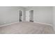 Neutral bedroom with plush carpeting, access to bathroom, and ample natural light at 4404 Cave Lake Ave, North Las Vegas, NV 89032