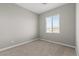 Bright bedroom with neutral carpet and a large window offering scenic views at 4404 Cave Lake Ave, North Las Vegas, NV 89032