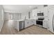 Modern kitchen boasts stainless steel appliances, quartz countertops, and an island at 4404 Cave Lake Ave, North Las Vegas, NV 89032