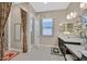 A well-lit bathroom featuring double sinks with a framed mirror and natural light at 444 Middlestone Ave, Henderson, NV 89011