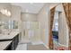 Bathroom with a glass shower, vanity with a sink and mirror, and easy access to the bedroom at 444 Middlestone Ave, Henderson, NV 89011