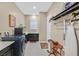 Modern laundry room with front load washer, shelving, storage, and a utility sink at 444 Middlestone Ave, Henderson, NV 89011
