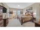 Spacious bedroom with carpet flooring, decorative furniture and decor, and a comfortable seating area near the window at 444 Middlestone Ave, Henderson, NV 89011
