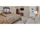 Main bedroom featuring a large bed, decorative furniture and decor, a seating area, and access to the outdoors at 444 Middlestone Ave, Henderson, NV 89011