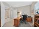 Cozy office space featuring a wooden desk and shelving, with a comfortable rolling chair and natural light at 444 Middlestone Ave, Henderson, NV 89011