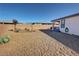 Spacious backyard featuring desert landscaping and a covered patio, perfect for outdoor relaxation at 4717 S Maddington Ct, Pahrump, NV 89061