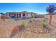 Low maintenance backyard with desert landscaping and a glimpse of the covered patio at 4717 S Maddington Ct, Pahrump, NV 89061