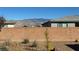 View of backyard with desert landscaping, brick wall, and stunning mountain views at 4717 S Maddington Ct, Pahrump, NV 89061