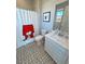 Bathroom showcasing patterned tile flooring and a Snoopy shower curtain at 4717 S Maddington Ct, Pahrump, NV 89061