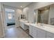 Bright bathroom featuring a view into the bedroom, double sinks, walk in shower and closet at 4717 S Maddington Ct, Pahrump, NV 89061