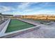 Outdoor bocce ball courts with manicured landscaping, mountain views, and clear blue skies at 4717 S Maddington Ct, Pahrump, NV 89061
