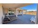 Enjoy outdoor living on this covered patio with neutral colors, ceiling fans, and access to a low-maintenance backyard at 4717 S Maddington Ct, Pahrump, NV 89061