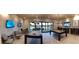 Well-lit game room featuring pool tables, TVs, bar seating, and outdoor access at 4717 S Maddington Ct, Pahrump, NV 89061