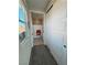 Hallway leading to a bathroom, featuring modern sliding closet doors at 4717 S Maddington Ct, Pahrump, NV 89061