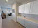 Hallway with a counter and cabinets, leading to a living area with a large television at 4717 S Maddington Ct, Pahrump, NV 89061