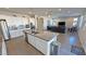 Open kitchen with stainless appliances, granite island with bar seating, open to the living area at 4717 S Maddington Ct, Pahrump, NV 89061