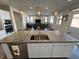 Spacious island in kitchen with granite countertops offers seating, open to the living area at 4717 S Maddington Ct, Pahrump, NV 89061