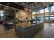 Open concept kitchen with island, stainless steel appliances, seating, and sleek lighting fixtures at 4717 S Maddington Ct, Pahrump, NV 89061