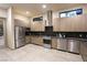 Modern kitchen with stainless steel appliances, gray cabinetry, and ample counter space at 4717 S Maddington Ct, Pahrump, NV 89061