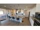 Modern kitchen boasts white cabinetry, granite counters, and a large island with pendant lighting at 4717 S Maddington Ct, Pahrump, NV 89061