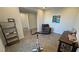 Flex space with an exercise bike, and desk with a comfortable lounge chair at 4717 S Maddington Ct, Pahrump, NV 89061