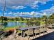 Scenic view of outdoor dining with a lake, water feature, trees, and mountains at Mountain Falls at 4717 S Maddington Ct, Pahrump, NV 89061