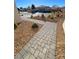 Paver sidewalk with desert landscaping and rock ground cover leading to front entry at 4717 S Maddington Ct, Pahrump, NV 89061