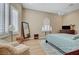 Bright bedroom features wood floors, shutters, ceiling fan, and cozy seating area at 4936 Mountain Foliage Dr, Las Vegas, NV 89148
