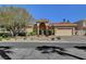 Beautiful single-story home with a red tile roof, lush landscaping, and a spacious driveway at 4936 Mountain Foliage Dr, Las Vegas, NV 89148
