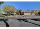 Charming front exterior featuring lush landscaping, mature trees, and a well-manicured lawn at 4936 Mountain Foliage Dr, Las Vegas, NV 89148