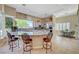 Spacious kitchen features granite countertops, stainless steel appliances and ample seating around the curved breakfast bar at 4936 Mountain Foliage Dr, Las Vegas, NV 89148