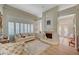 Inviting living room featuring wood floors, fireplace, large windows with shutters and comfortable seating at 4936 Mountain Foliage Dr, Las Vegas, NV 89148