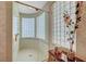 Glass shower with a tiled surround and a window with glass blocks for privacy at 4936 Mountain Foliage Dr, Las Vegas, NV 89148