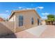 A lovely backyard has a cozy patio area with decorative rocks along the house's perimeter at 5031 Droubay Dr, Las Vegas, NV 89122