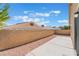 Private backyard features a concrete patio, rock landscaping, and block wall fence at 5031 Droubay Dr, Las Vegas, NV 89122