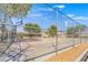 Community basketball court with metal fencing and mature shade trees, perfect for recreation at 5031 Droubay Dr, Las Vegas, NV 89122