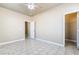 Open bedroom with tile floors, ceiling fan, and access to the closet and bathroom at 5031 Droubay Dr, Las Vegas, NV 89122