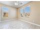 Bright bedroom with three windows featuring modern window coverings and neutral tile floors at 5031 Droubay Dr, Las Vegas, NV 89122