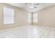 Bright, spacious bedroom with tile floors, a ceiling fan and three windows at 5031 Droubay Dr, Las Vegas, NV 89122