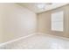 Empty bedroom with tile floors, ceiling fan, and window with modern blinds at 5031 Droubay Dr, Las Vegas, NV 89122
