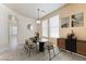 Sunlit dining room with modern lighting, neutral paint, and large windows at 5031 Droubay Dr, Las Vegas, NV 89122