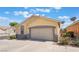 Single-story home features a two-car garage, desert landscaping, and a traditional facade at 5031 Droubay Dr, Las Vegas, NV 89122