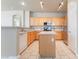 Kitchen with stainless steel appliances, wood cabinets, white countertops, and kitchen island at 5031 Droubay Dr, Las Vegas, NV 89122