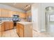 Kitchen area featuring stainless steel appliances, wood cabinets, white countertops, and kitchen island at 5031 Droubay Dr, Las Vegas, NV 89122
