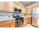Close up of the kitchen featuring stainless steel appliances, wood cabinets, and white countertops at 5031 Droubay Dr, Las Vegas, NV 89122