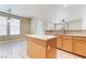 Kitchen with island, tile flooring and view to the dining and living areas at 5031 Droubay Dr, Las Vegas, NV 89122