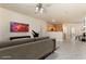Comfortable living room showcasing tile floors, and an open floor plan leading to the kitchen at 5031 Droubay Dr, Las Vegas, NV 89122