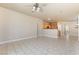 Spacious open-concept living area featuring tile floors, neutral walls, and seamless transition to the kitchen at 5031 Droubay Dr, Las Vegas, NV 89122