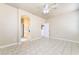 Bright main bedroom with tile floors, a ceiling fan, ensuite bathroom and walk in closet at 5031 Droubay Dr, Las Vegas, NV 89122