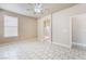 Bright main bedroom with tile floors, a ceiling fan, and an ensuite bathroom at 5031 Droubay Dr, Las Vegas, NV 89122